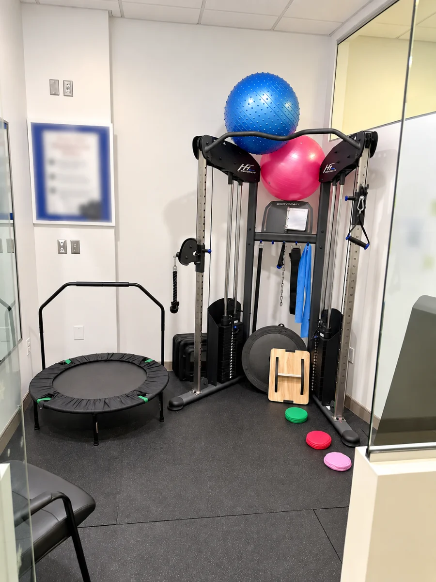 An exercise and rehabilitation room with fitness equipment at the Critical Trauma Therapy St. Catharines clinic