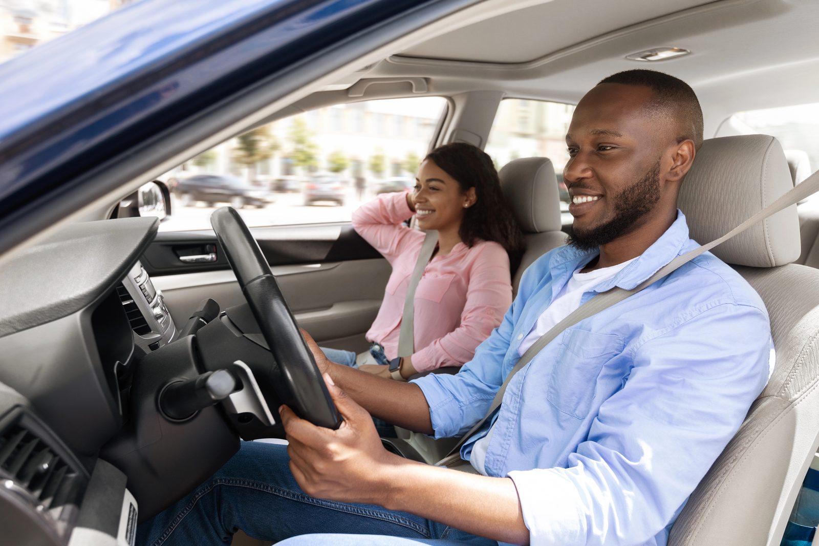 A driver gripping the steering wheel, illustrating driving-related anxiety after a car accident