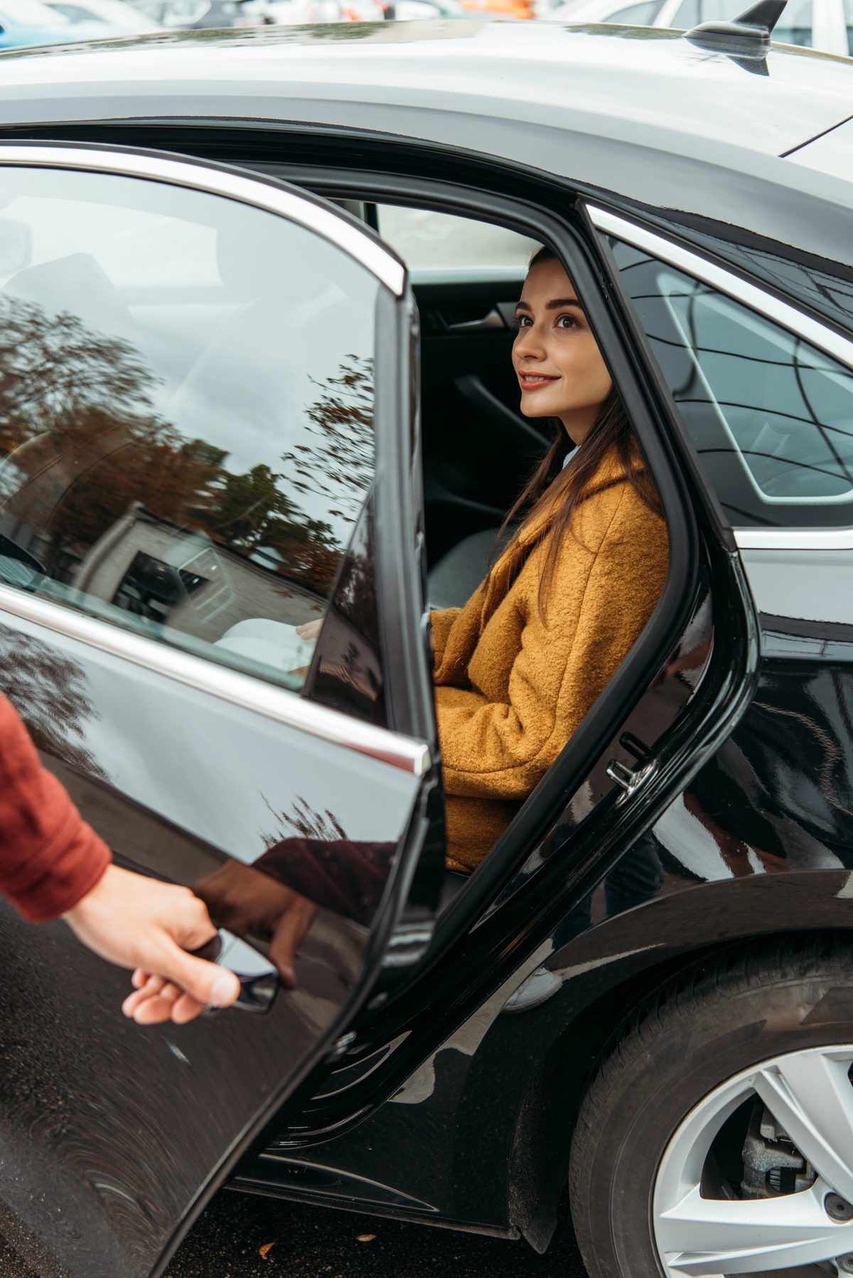 Woman getting into a car, taking a first step back toward driving